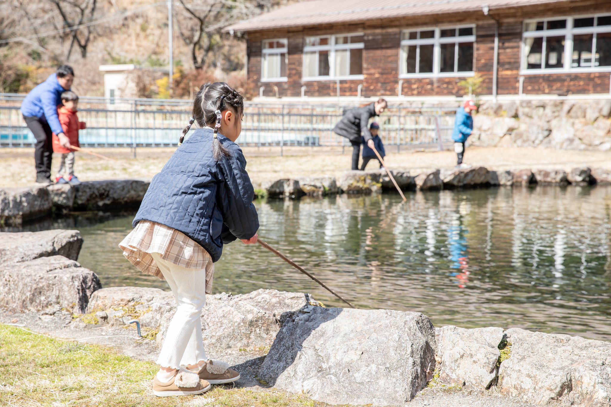 笑顔で魚を釣り上げる親子